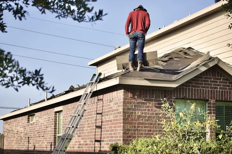 Professional roofer working on a residential roof in North Castle